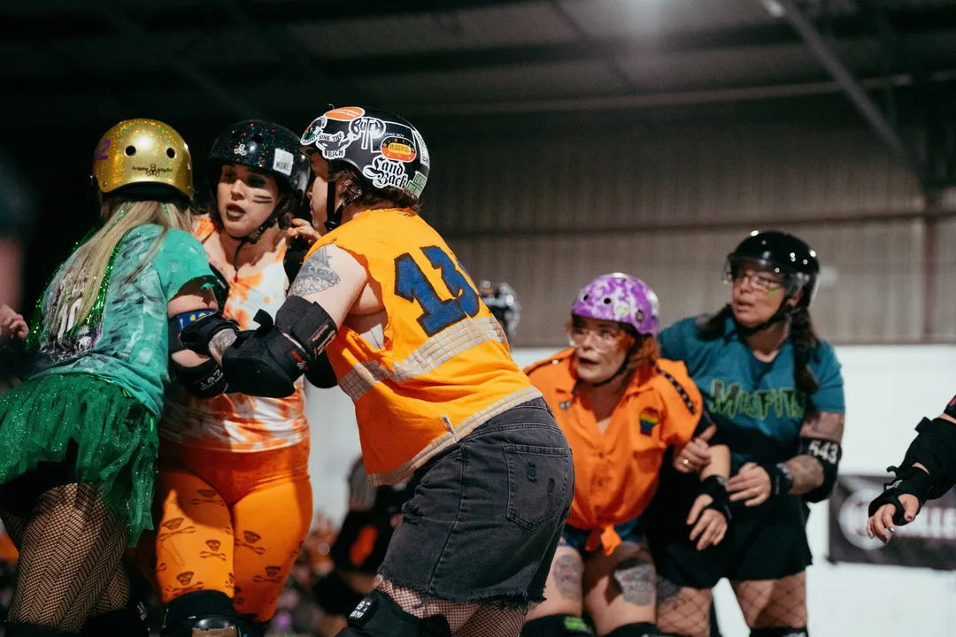 Blockers in green and orange collide mid-jam