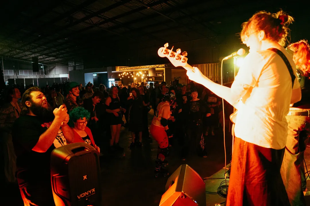 A guitarist plays out to the crowd of skaters