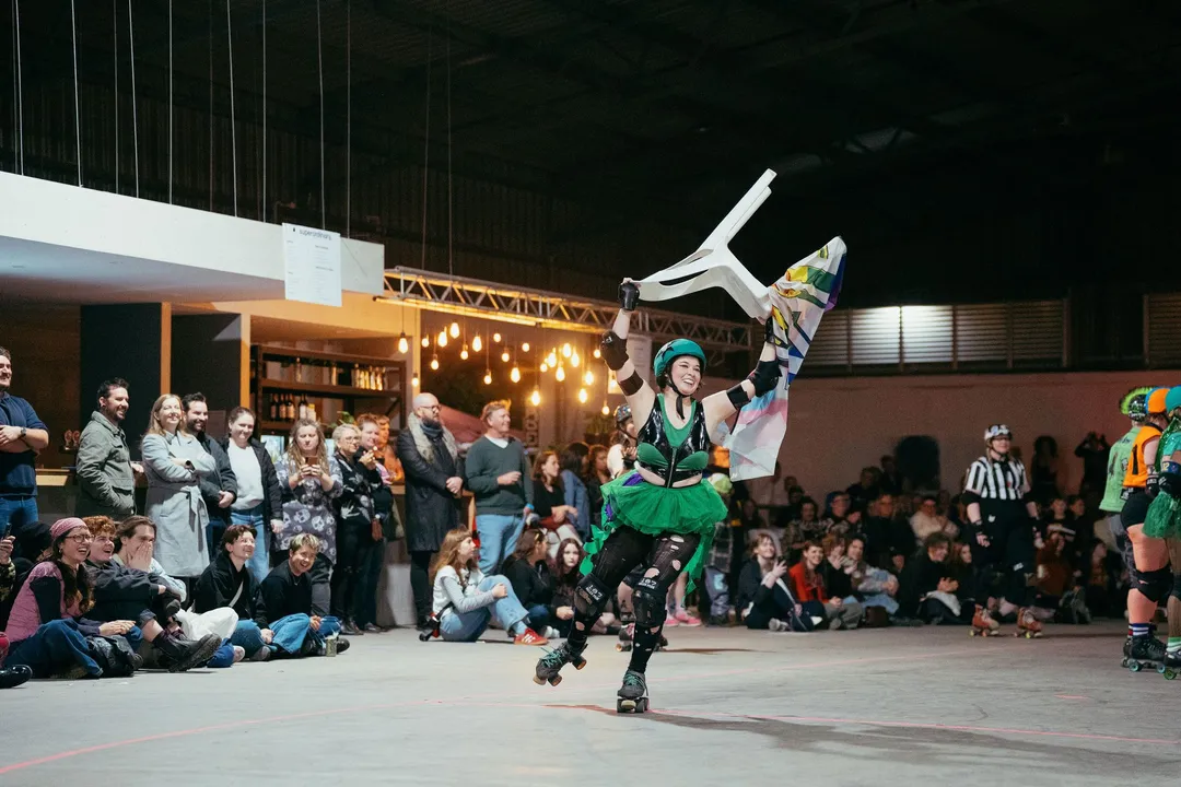 A skater kicks up into a handstand on the track